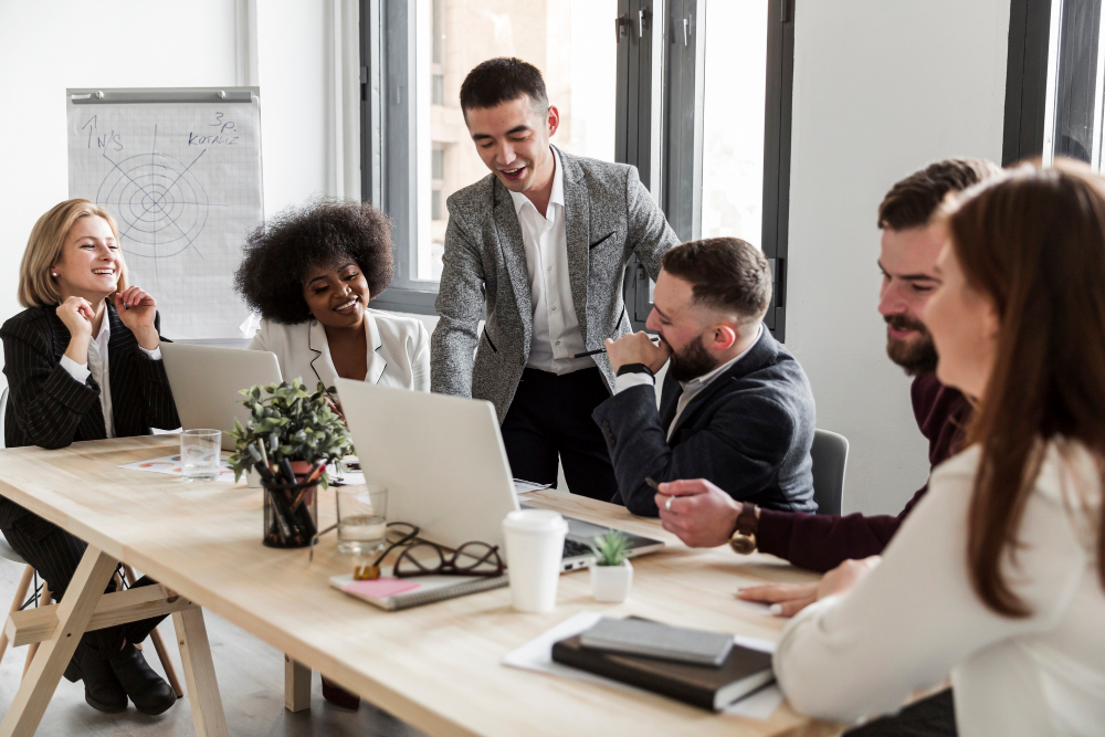 Office employees gathered around a desk